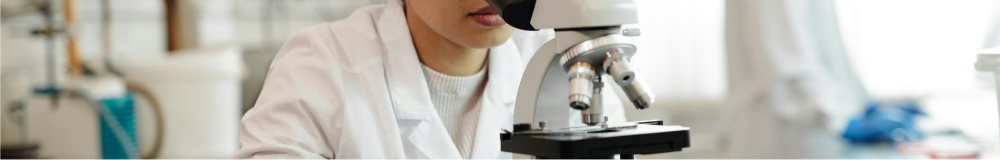 Image of woman looking through a microscope